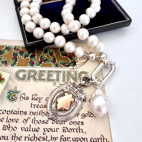 Vonk Jewellery 1931 watch fob and pearl necklace on a vintage Christmas postcard and vintage jewellery box