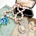 Vonk Jewellery pale pink pearl and vintage watch fob necklace on a vintage jewellery box and with vintage postcards.