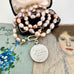 Vonk Jewellery pale pink pearl and vintage watch fob necklace on a vintage jewellery box and with vintage postcards.