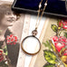 Vonk Jewellery rolled gold antique locket necklace on a vintage postcard and with a vintage jewellery box