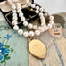 Vonk Jewellery rolled gold vintage locket and pearl necklace on a vintage jewellery box and vintage postcards
