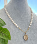 Vonk Jewellery rolled gold vintage locket and pearl necklace on a vintage jewellery box and vintage postcards