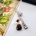 Vonk Jewellery Victorian sterling silver propelling pencil with garnet and pearl charms with a vintage postcard and box