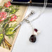 Vonk Jewellery Victorian sterling silver propelling pencil with garnet and pearl charms with a vintage postcard and box