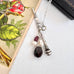 Vonk Jewellery Victorian sterling silver propelling pencil with garnet and pearl charms with a vintage postcard and box