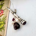 Vonk Jewellery Victorian sterling silver propelling pencil with garnet and pearl charms with a vintage postcard and box