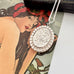 Vonk Jewellery 1977 sterling silver engraved locket on a vintage jewellery box and with a card of a woman with red flowers in her hair