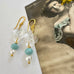 Vonk Jewellery vintage glass crystal, aqua and pearl earrings on a vintage postcard