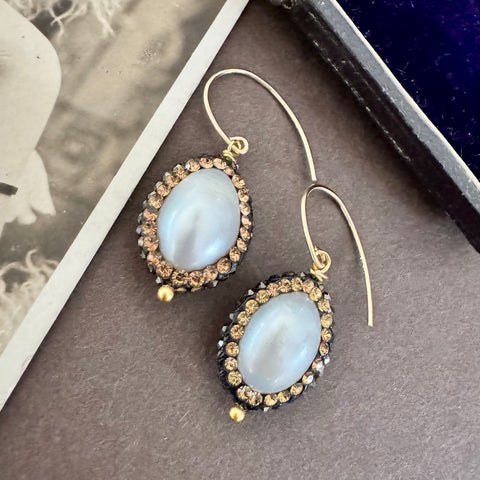Vonk Jewellery vintage inspired pearl and crystal earrings on a brown background and with a vintage postcard
