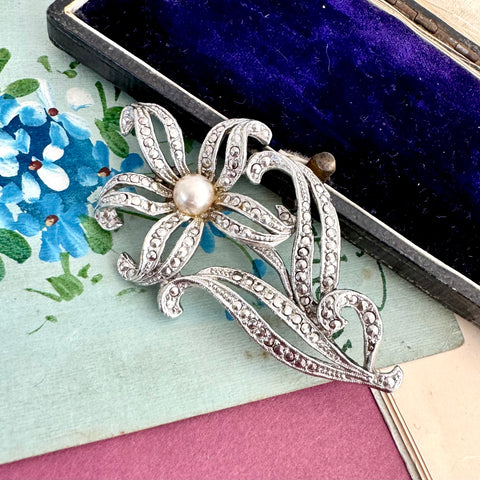 Vonk Jewellery large vintage marcasite flower brooch on a vintage postcard and with a vintage jewellery box
