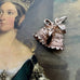 Vonk Jewellery vintage silver bells and ribbon charm on a portrait on a young Queen Victoria