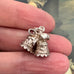 Vonk Jewellery vintage silver bells and ribbon charm in a woman's hand