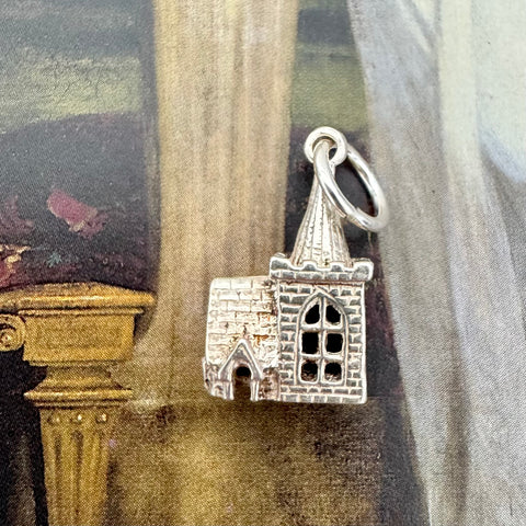 Vonk Jewellery vintage silver church charm on an old painting 