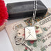 Vonk Jewellery vintage stamp case necklace on a vintage postcard and vintage jewellery box