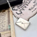 Vonk Jewellery vintage stamp case necklace on a vintage postcard and vintage jewellery box