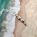 Vonk Jewellery vintage female swimmer or diver sterling silver charm on an image of the sand and sea