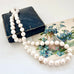 Pearl necklace on an old book with floral design
