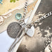 Vonk Jewellery 1889 threepence sterling silver charm bracelet on vintage postcards.