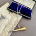 Vonk Jewellery antique pocket watch key necklace on a vintage jewellery box and vintage postcard