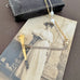 Vonk Jewellery antique pocket watch key necklace on a vintage jewellery box and postcard
