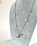 Vonk Jewellery antique pocket watch key necklace on a grey velvet jewellery display neck