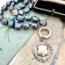 Vonk Jewellery peacock pearl and vintage silver watch fob necklace on 2 vintage postcards and with a vintage jewellery box