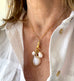 Image of a woman's neck. She is wearing Vonk Jewellery double sided photo locket and a white linen shirt