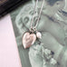 Vonk Jewellery vintage silver heart and pearl charm necklace on a vintage postcard