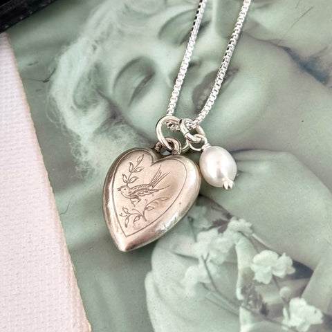 Vonk Jewellery vintage silver heart and pearl charm necklace on a vintage postcard