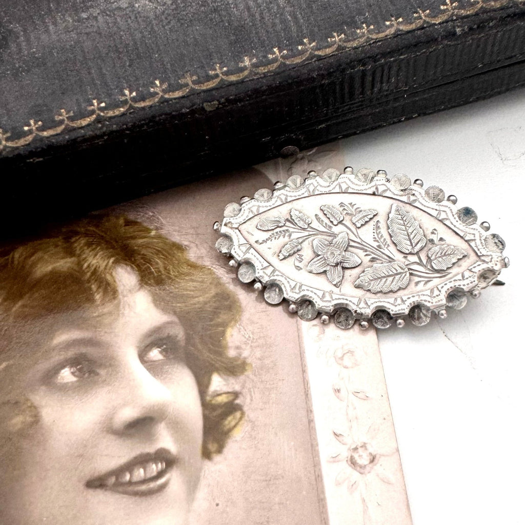 Vonk Jewellery victorian sterling silver aesthetic brooch with a vintage jewellery box and a vintage postcard