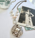 Vonk Jewellery c1880s Victorian buckle locket on pearl and silver chain and with a vintage postcard