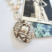 Vonk Jewellery c1880s Victorian buckle locket on pearl and silver chain and with a vintage postcard