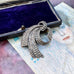 Vonk Jewellery vintage sterling silver marcasite brooch on a postcard of a a woman and a vintage jewellery box