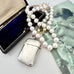 Vonk Jewellery 1889 sterling silver vesta case and pearls on a vintage postcard and with a vintage jewellery box