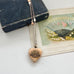 WW2 ACMF heart-shaped pendant  sweetheart locket on a chain against an old letter background