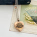 WW2 ACMF heart-shaped pendant  sweetheart locket on a chain against an old letter background