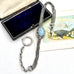 Antique French silver albertina chain , displayed next to its dark blue velvet box and a decorative fan card.