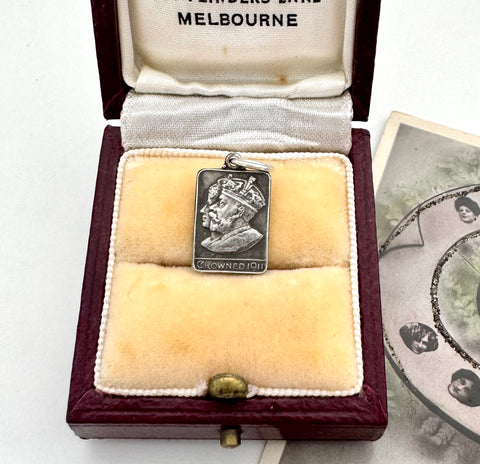 Antique silver charm commemorating the coronation of George   and Queen Mary in a jewellery box