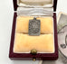 Antique silver charm commemorating the coronation of George  and Queen Mary in a jewellery box. It has the words of God Save the King on the back