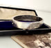 Antique silver bangle on an old jewellery box and with an old photograph