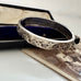 Silver bracelet with leaf patterns in an open jewellery box
