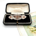 Antique Victorian silver and rose gold brooch on an old jewellery box