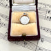 Silver vintage spinning I Love You charm in a jewelry box on sheet music