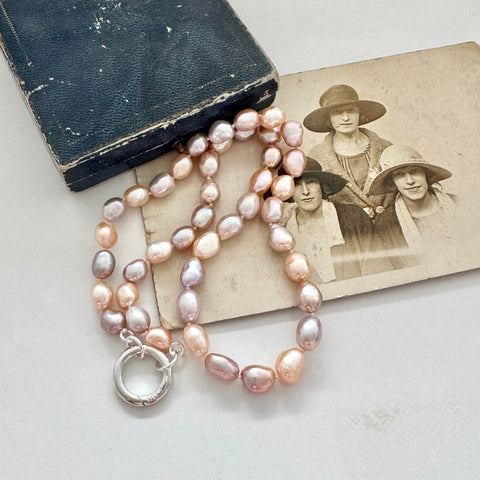 Pearl necklace on an old photograph with a black jewellery box