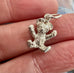 Vonk Jewellery silver teddy bear charm on an old picture of a child from a Womans Weekly magazine and in a woman's hand