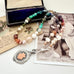 Vonk Jewellery 1933 watch fob multi pearl, crystal and gemstone necklace on a vintage jewellery box and vintage postcards 