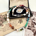 Vonk Jewellery 1933 watch fob multi pearl, crystal and gemstone necklace on a vintage jewellery box and vintage postcards 