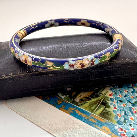 Vintage blue cloisonne bangle on an old jewellery box with a vintage Christmas postcard