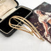 Vintage Sarah Coventry signed "stunning" gold tone brooch on an old jewellery box and with a vintage postcard