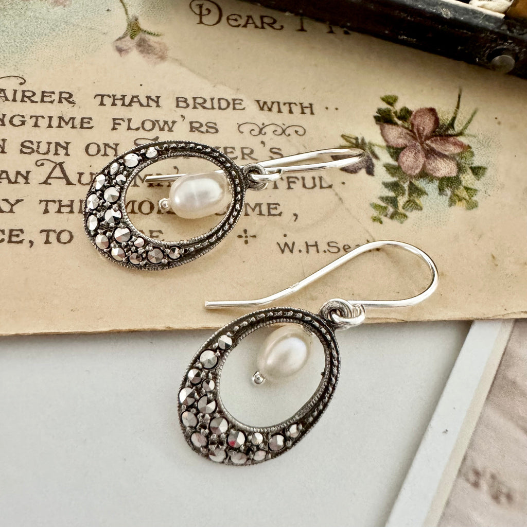 Vonk Jewellery vintage marcasite and pearl earrings on a vintage postcard